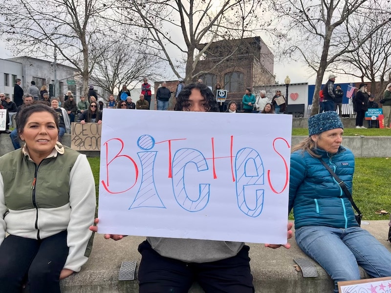 sign boy mom ICE protest
