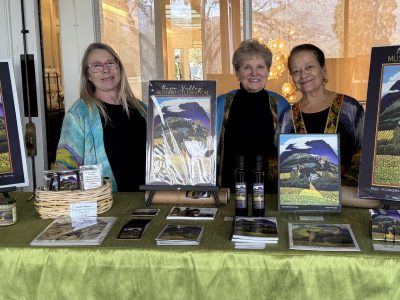 Heather Hamilton, Jessel Miller and Nouria Harris stand with copies of this year's poster art at the sold-out Jan. 17 launch of the 2026 Mustard Celebration held at Silverado Resort. Submitted photo